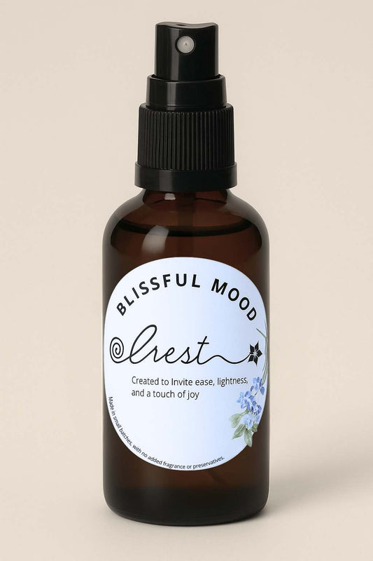 Amber glass spray bottle of Crest Blissful Mood Spritz with floral label – uplifting herbal mist to enhance joy and emotional balance.