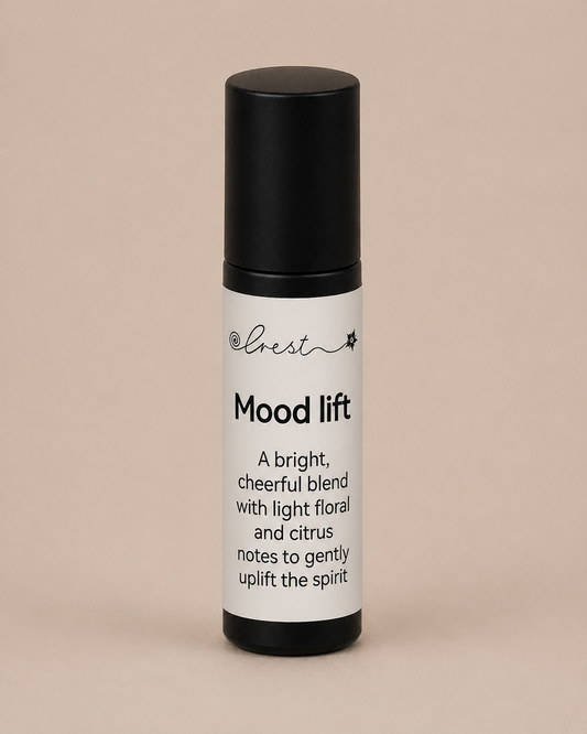 Black stainless steel roll-on applicator with Mood Lift essential oil blend to uplift mood with bright citrus and floral notes