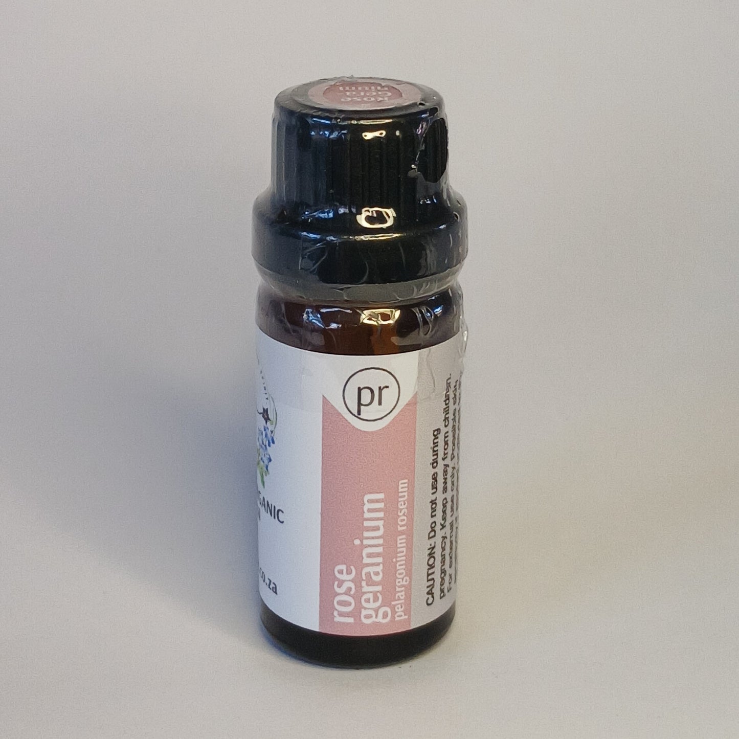 Rose Geranium essential oil bottle by Crest for floral aromatherapy, skincare and emotional wellness rituals
