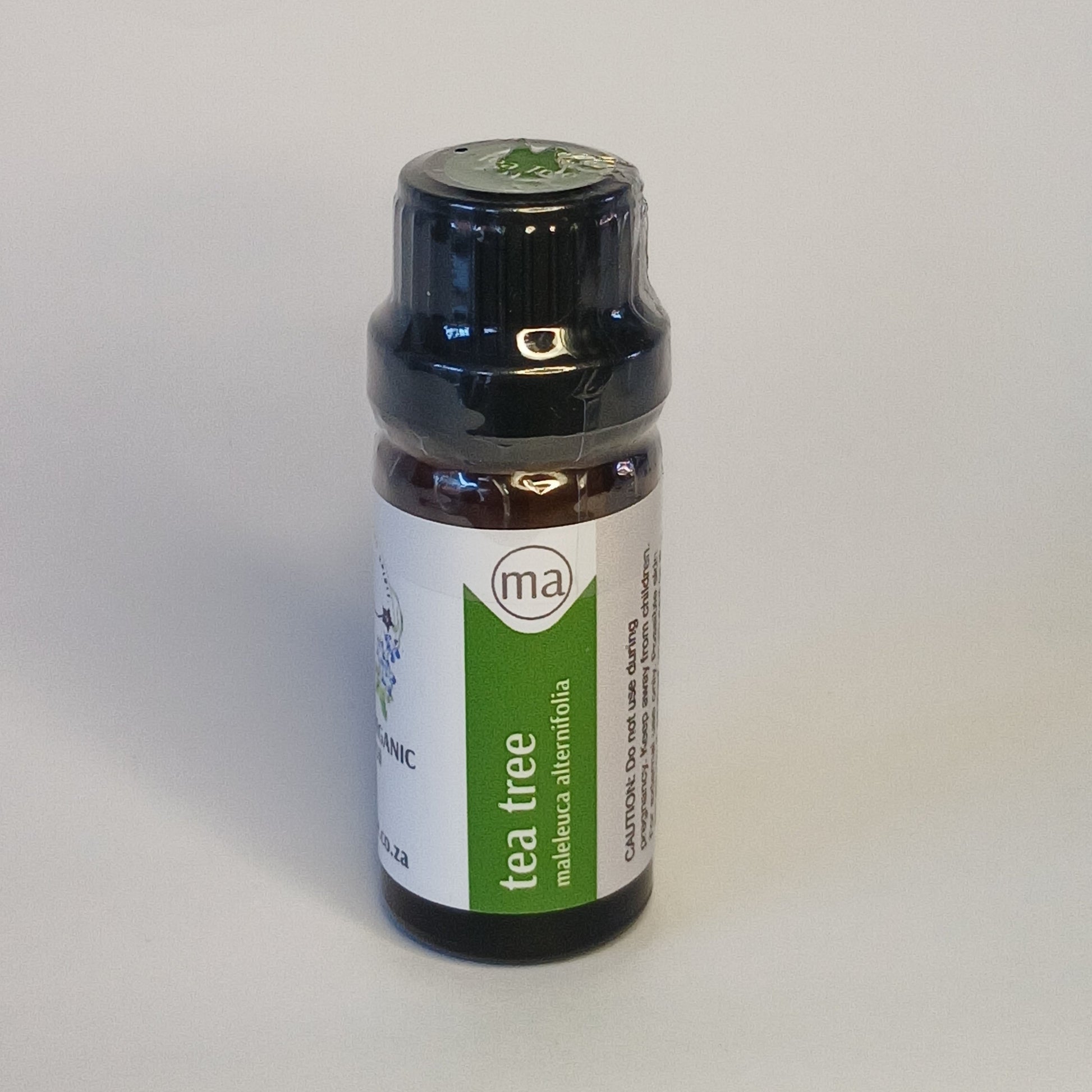 Tea Tree essential oil bottle by Crest for purifying aromatherapy, skincare and botanical wellness rituals